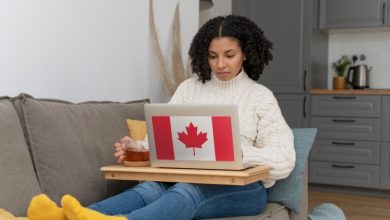 woman working from home laptop with Canadian flag